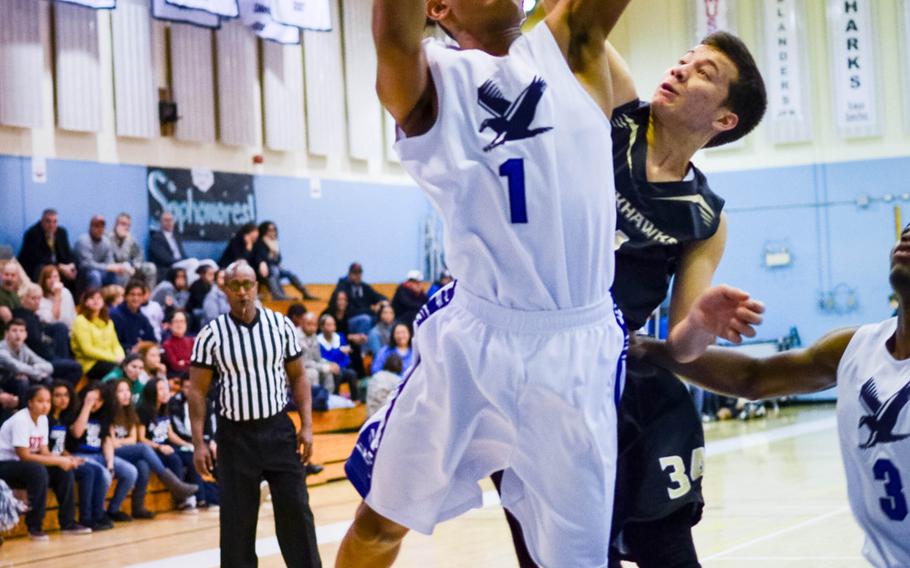 Seoul American's James Daniel puts up a shot against Humphreys' Osie Cruz during Wednesday's Korean-American Interscholastic Activities Conference Blue Division boys high school basketball game at Yongsan Garrison, South Korea. The Falcons won 71-17.