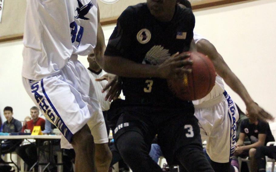 Daegu's Tre Johnson tries to drive around Seoul American's Shawn Horne to the basket during Saturday's championship game in the Korean-American Interscholastic Activities Conference Blue Division boys basketball tournament at Daejon, South Korea. The Warriors won 60-59, ending the Falcons' three-year hold on the tournament title.