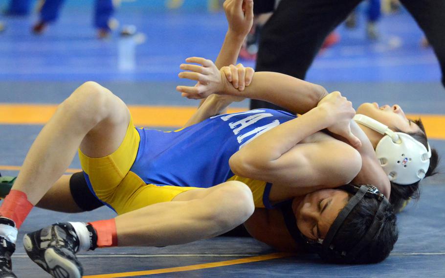 St. Mary's Chang Young Lee executes a reverse press on Kadena's Tasi Duenas during Friday's 101-pound championship bout in the 37th Far East High School Wrestling Tournament at Yokota Air Base, Japan. Lee won by pin in 1 minute, 19 seconds.