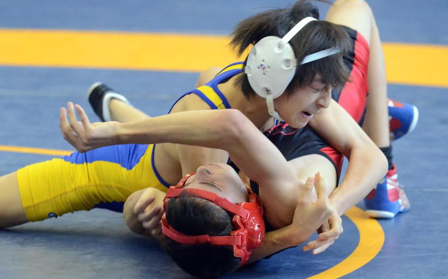 St. Mary's International's Chang Young Lee finishes off Nile C. Kinnick's Vincent Soiles during Saturday's 101-pound bout in the Division I dual-meet final of the 37th Far East High School Wrestling Tournament at Yokota Air Base, Japan. Lee won by pin.