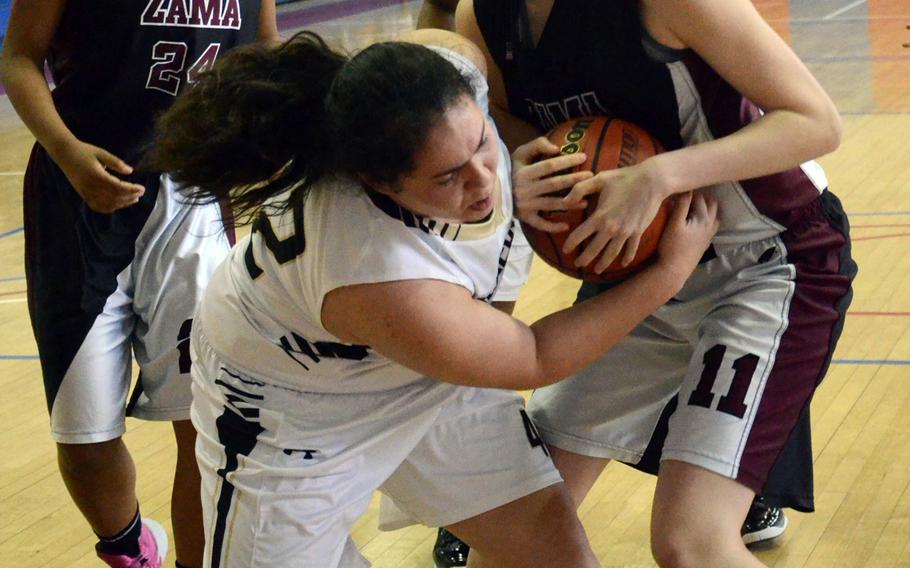 Humphreys' Sophia Nocera and Zama's Alexandra Chiarenza battle for the ball as Zama's Destinee Howze watches during Monday's pool-play game in the Far East High School Girls Division II Basketball Tournament at Camp Walker, South Korea. Zama won 14-9.
