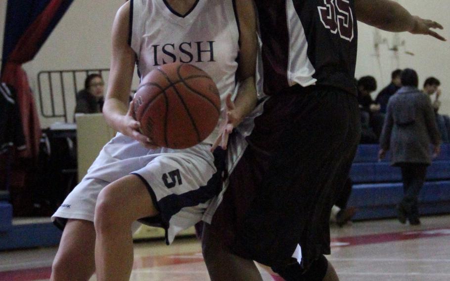 International School of the Sacred Heart's Christianna Dale tries to drive against Zama American's Niyah Lewis during Tuesday's double-elimination playoffs in the Far East High School Girls Division II Basketball Tournament at Camp Walker, South Korea. Zama won 54-52 in overtime.