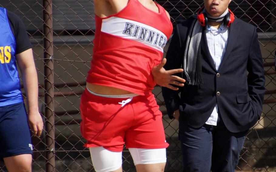 Nile C. Kinnick senior Ian O'Brien tosses the shot 12.41 meters during a preliminary round in the DODDS Japan/Kanto Plain season-opening track and field meet at Yokota Air Base, Japan. O'Brien won the event.