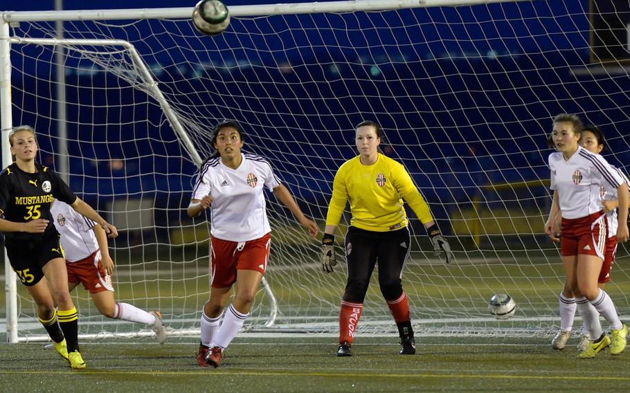 American School In Japan's Katey Helwick eyes the ball along with Nile C. Kinnick's Alicia Martinez, Courtney Bacon and Charla Johnson during Wednesday's Kanto Plain Association of Secondary Schools girls soccer match at Yokosuka Naval Base, Japan. The Red Devils won 3-1, handing the Mustangs their first Kanto Plain regular-season loss since a 1-0 defeat on May 11, 2012.