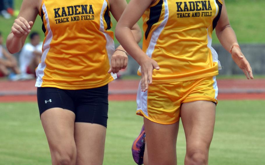 Kadena distance duo Ana Hernandez and Wren Renquist run side-by-side in the 1,600 during Saturday's Okinawa track and field meet at Mihama, Okinawa. Hernandez and Renquist placed 1-2 in 5 minutes, 47.95 seconds and 5:49.31.