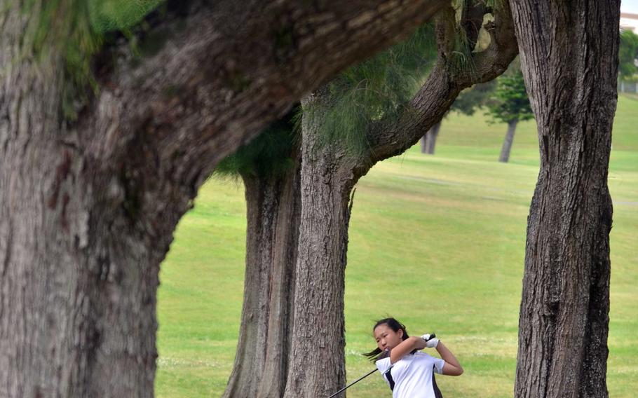 Dwarfed by pine trees on the right side of the fairway, Kadena's Nurie Howell hits an approach shot on the 456-yard, par-4 11th hole during Wednesday's first round of the Okinawa district golf finals on the 6,714-yard, par-72 Banyan Tree Golf Course on Kadena Air Base, Okinawa. Howell carded a 113; the second and final round is scheduled for Friday at Taiyo Golf Course in Gushikawa.