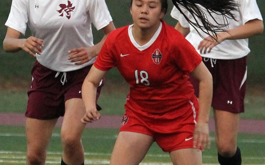 Nile C. Kinnick's Kiralyn Kawachi tries to settle the ball in front of Matthew C. Perry's Kahlei Van Ostran and Emily Gilbert during Thursday's round-robin game in the DODDS Japan high school girls soccer tournament at Camp Zama, Japan. Kinnick routed Perry 9-1.