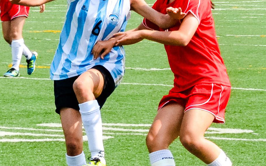 Osan's Evie Garrido and Seoul Foreign's Skye Chung try to control the ball during Friday's semifinal match in the Korean-American Interscholastic Activities Conference Blue Division high school girls soccer tournament at  Yongsan Garrison, South Korea. The Crusaders beat the Cougars 6-1.