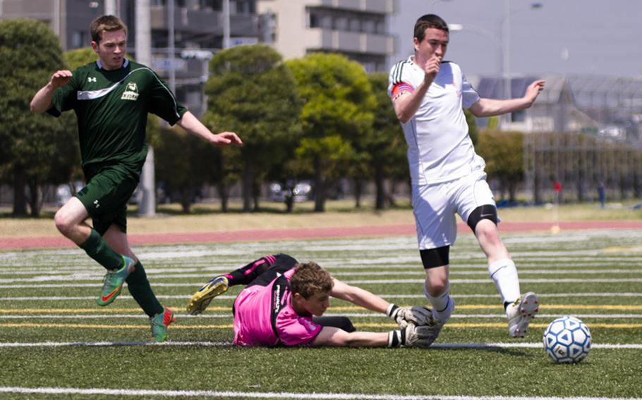 Nile C. Kinnick's Ian Dignan gets by Austin Burdick of Robert D. Edgren as he attempts a shot during pool play of the DODDS Japan Boys Soccer Tournament in Yokota, Japan on Friday. Dignan's shot would go wide.