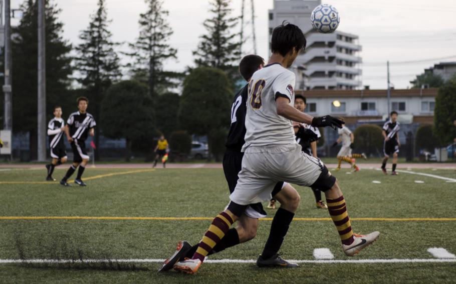 Gaku Lange of M.C. Perry beats a defender from Zama to the ball and heads it in play during a semifinal match of the DODDS Japan Boys Soccer Tournament on Friday in Yokota, Japan. Lange would net a hat trick and record four assists in Perry's 7-1 victory.