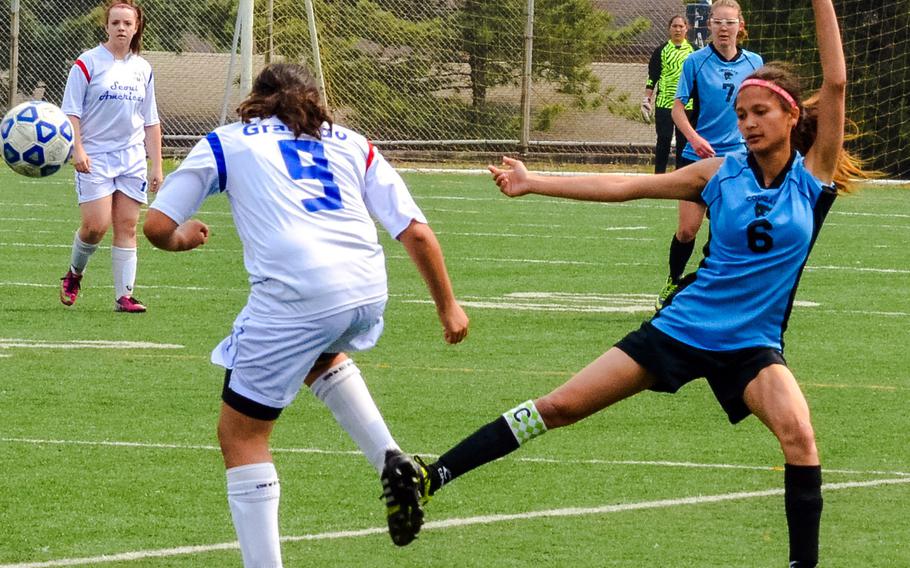 Seoul American's Kayla Granado and Osan's Evie Garrido tussle for the ball during Saturday's third-place match in the Korean-American Interscholastic Activities Conference Blue Division high school girls soccer tournament at South Korea. The Cougars edged the Falcons 3-2.