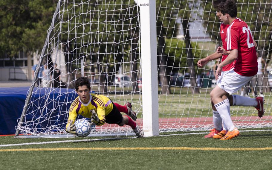 Brady Yoder makes a diving save in the second half of the DODDS Japan Boys Soccer Tournament Championship on Saturday in Yokota, Japan. Perry won the tournament title 1-0.