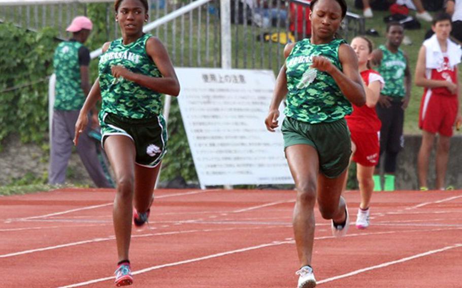 Kubasaki's Kourtney Mitchell and Kaelyn Francis run side-by-side in the 200-meter dash during Saturday's Okinawa district track and field finals at Mihama, Okinawa. Francis and Mitchell finished 1-2 in the 100 and 200, clocking 27.02 and 27.48 seconds in the latter.