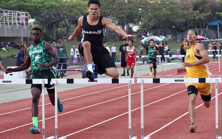Ziion Christian Academy's Daril Anthes leaps a hurdle, sandwiched by Kubasaki's Tristan McElroy and Kadena's Leslie Williams during Saturday's  Okinawa district track and field finals at Mihama, Okinawa. Anthes won in 42.30 seconds, McElroy was second in 42.63 and Williams third in 42.85.