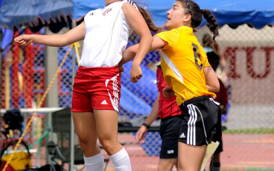 Nile C. Kinnick's Kaile Johnson leaps to head the ball before American School In Japan's Maya Tromburg during a semi-finals match of the Far East Division I girl's soccer tournament at Camp Foster, Okinawa, May 21, 2014. 