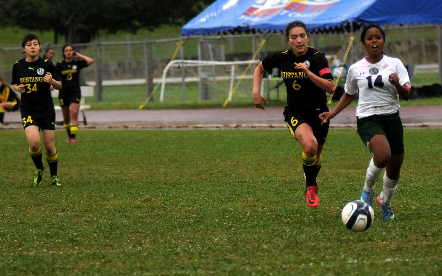 American School in Japan's Maya Tromburg and Kubasaki's Alysha Gilliard race for the ball at the Far East Division 1 girls soccer championship on Camp Foster, Okinawa, May 22, 2014.