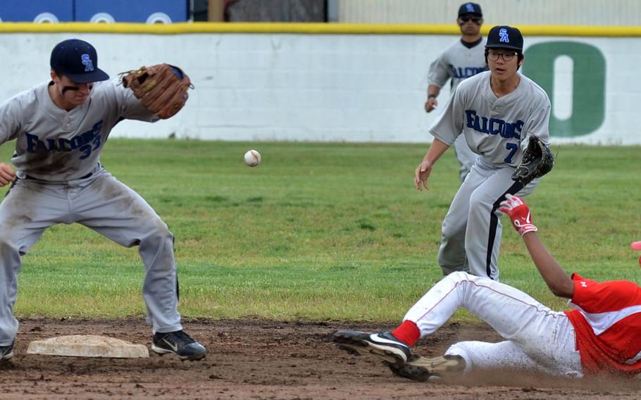 Seoul American's Charlie Dillon can't find the handle on the ball as Nile C. Kinnick's Joshua Thompson slides in safely at second base in Friday's Far East Division I Baseball Tournament quarterfinal, won by Kinnick 4-0.