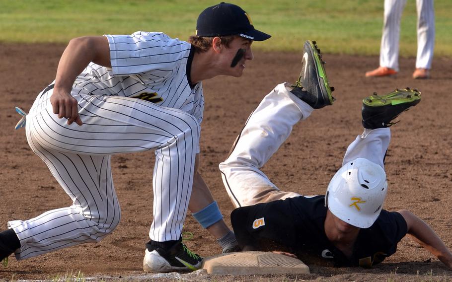 American School In Japan first baseman Ryan Glasenapp puts the tag on Kadena's Justin Sego in Saturday's Far East Division I baseball tournament final, won by ASIJ 3-0. Sego was called safe on the play.