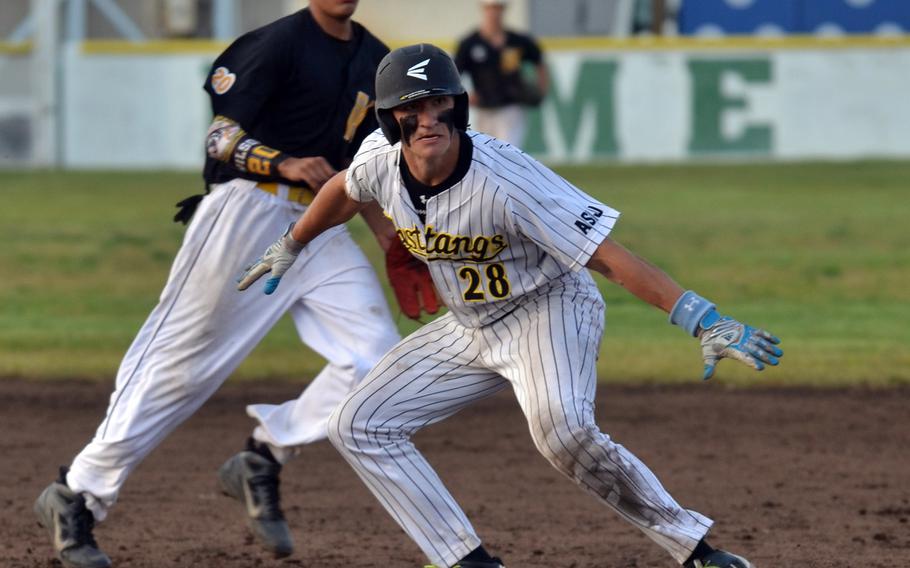 American School In Japan baserunner Ryan Glasenapp realizes he's caught in a rundown as Kadena shortstop Justin Wilson moves into position to make a play during Saturday's Far East Division I baseball tournament final, won by ASIJ 3-0.