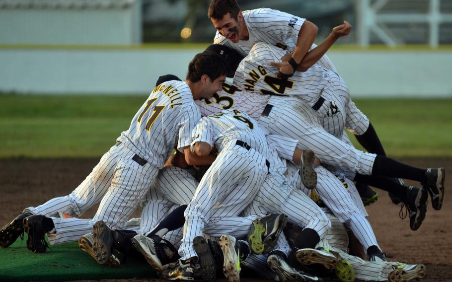 American School In Japan players pile on each other at the pitcher's mound following Saturday's Far East Division I baseball tournament final, won by ASIJ 3-0 over Kadena.