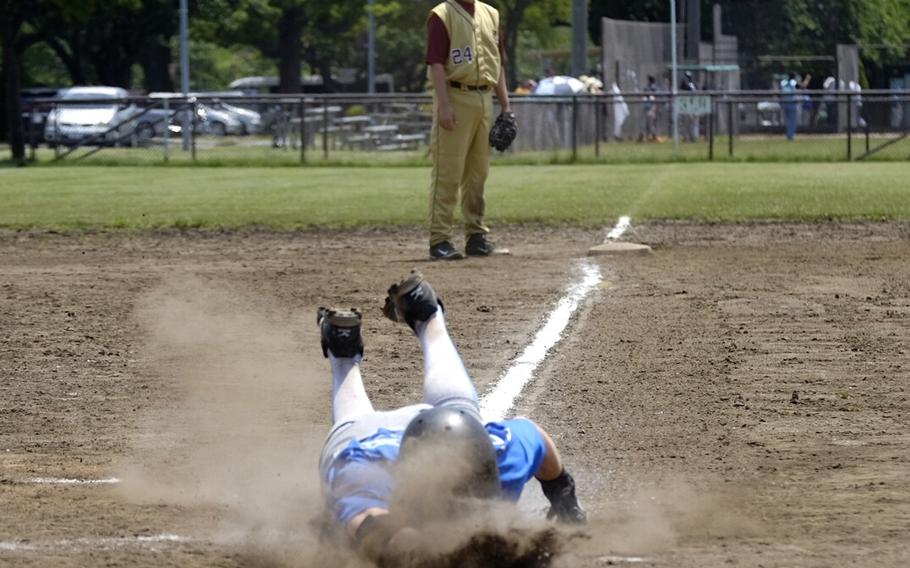 Osan's Andrew Lowe slides head first into home completing an inside the park home run against Robert D. Edgren in the third place game of the Far East Division II baseball tournament May 24 at Camp Zama, Japan. Edgren won 11-3. 