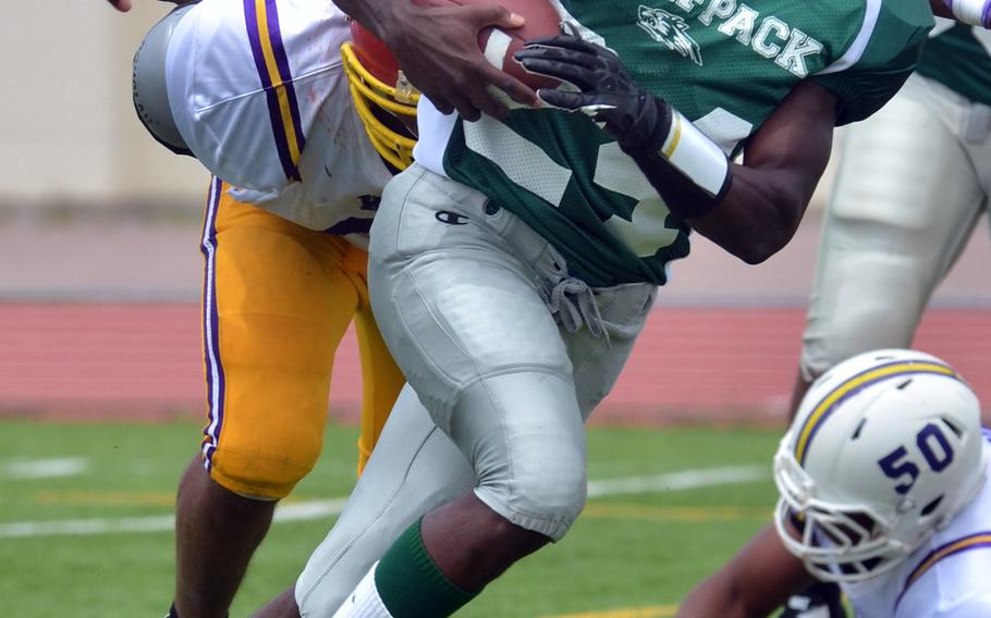 Hansen QB Alexander Williams looks for running room upfield against Kinser.