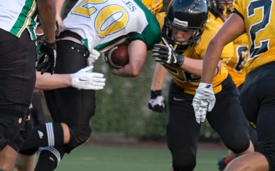 Robert D. Edgren running back Nicholas Cunniff fights for extra yards against the ASIJ defense during the 2014 DODDS Pacific season opener Friday, Sept. 5 in Chofu, Japan. ASIJ shut out Edgren 39-0.