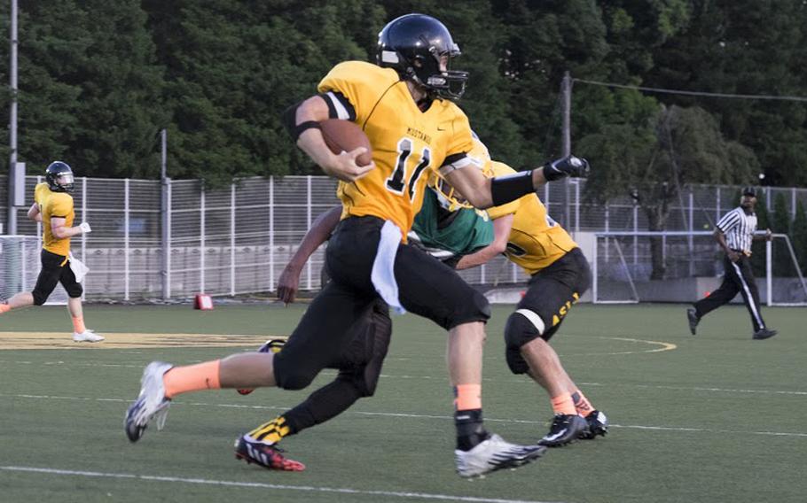ASIJ quarterback Brandon Rogers scrambles against Robert D. Edgren during the Mustangs' 2014 season opener Friday, Sept. 5 in Chofu, Japan. Rogers threw for one score in a 39-0 victory. 