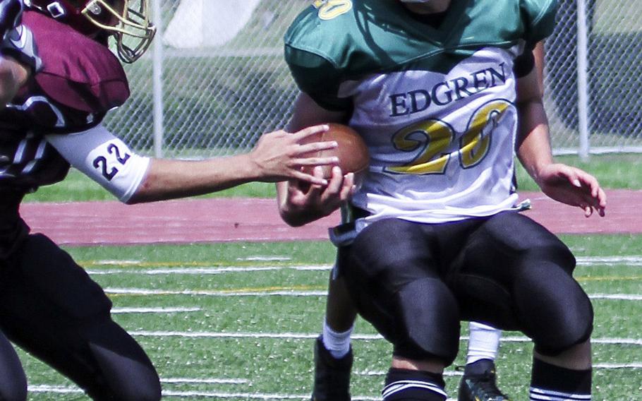 Edgren running back Nick Cunniff looks for running room Saturday against Perry defender Andrew Jenkins.