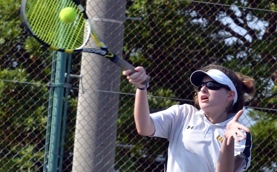 Kadena's Lily Oliver hits a forehand smash en route to a 6-0, 6-0 shutout of Kubasaki's Allie Powers in Thursday's tennis tie. Kubasaki girls won for the second straight week 5-3.