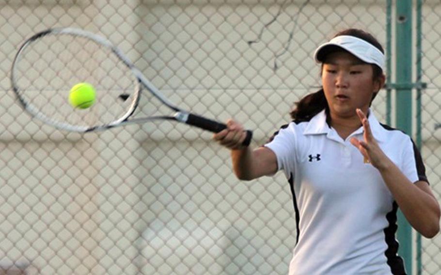 Kadena's Nurie Howell uses a forehand return during an 8-3 doubles loss to Kubasaki's Mary Neitzke and Sarah Walter during Thursday's Okinawa tennis tie. Kubasaki as a team won for the second straight week 5-3.