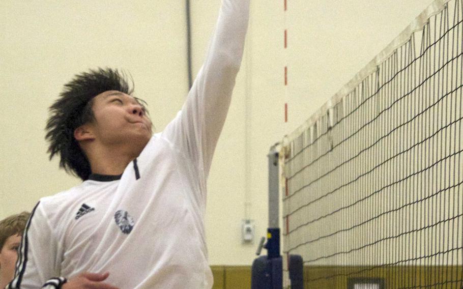 Hanbin Lee, of Daegu goes high to the net against Yongsan International-Seoul in Friday's KAIAC boys volleyball match at Camp George, South Korea. The Guardians beat the Warriors 25-17, 25-18, 25-21.