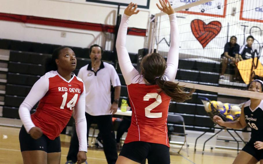 Nile C. Kinnick's Charla Johnson sets the ball to teammate Audri Salter against Zama during Tuesday's DODDS Japan/Kanto Plain Association of Secondary Schools regular-season volleyball match at Camp Zama, Japan. The Red Devils swept the Trojans 25-14, 25-22, 25-15.
