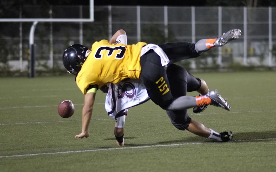 American School In Japan defensive back Ray Hotta forces Matthew C. Perry wide receiver Tyson Moore to drop a pass in the third quarter of the Mustangs and Samurai game in Chofu, Japan on Oct. 3, 2014. The Mustangs won 41-0.