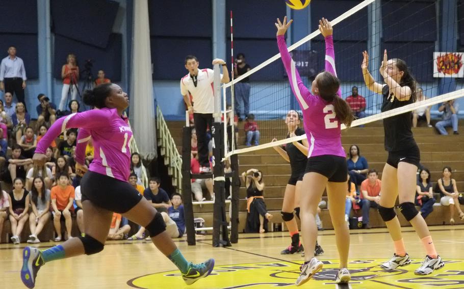 Nile C. Kinnick's Charla Johnson sets up Audri Salter for a spike during the Red Devils' match against American School In Japan Oct. 3 in Chofu, Japan. The Devils would lose in straight sets 25-17, 25-19, 27-25.