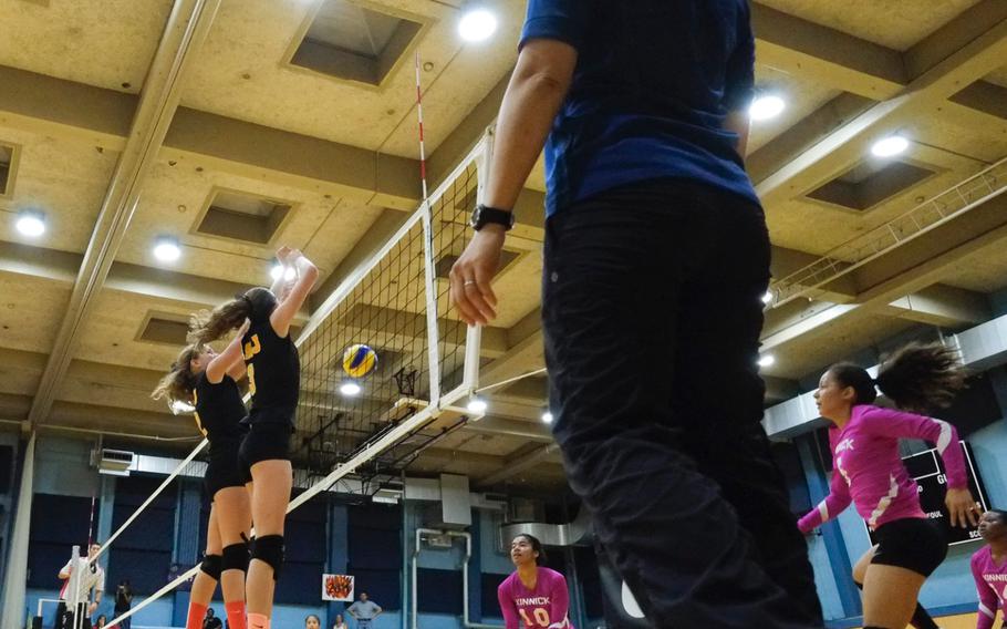 American School In Japan defenders block a spike attempt against rival Nile C. Kinnick on Friday, Oct. 3, 2014, in Chofu, Japan. ASIJ would win in straight sets 25-17, 25-19, 27-25.