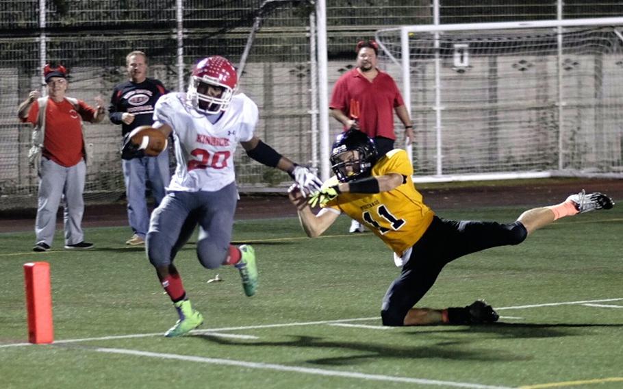 Nile C. Kinnick running back Dre Paylor gets past American School In Japan linebacker Brandon Rogers on his way to the endzone during the third quarter of the Red Devils and Mustangs game Friday in Chofu, Japan. The Red Devils lost 15-9, their first defeat of the year. 