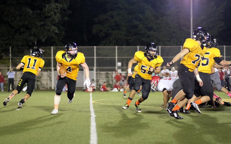 American School In Japan running back Ryan Murphy takes the handoff Friday in the second quarter of the Mustangs' 15-9 upset of previously undefeated Nile C. Kinnick in Chofu, Japan. 
