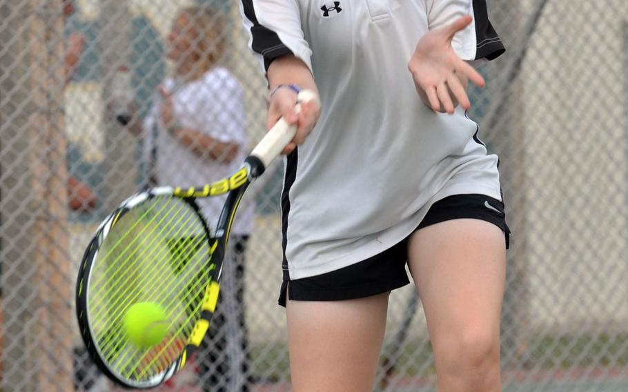 Kadena freshman Lily Oliver delivers a forehand return Thursday en route to her first Okinawa district singles tennis tournament title at Camp Foster, Okinawa.