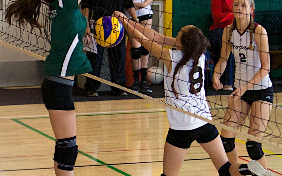 Robert D. Edgren's Kalean Middleton blocks Zama's Parish Hingel's shot at the net as Zama's Rachel Norton watches during Saturday's DODDS Japan volleyball match. The Eagles won 25-9, 25-14, 25-21, completing a sweep of their two-match series with the Trojans and staying unbeaten against Division II opponents.
