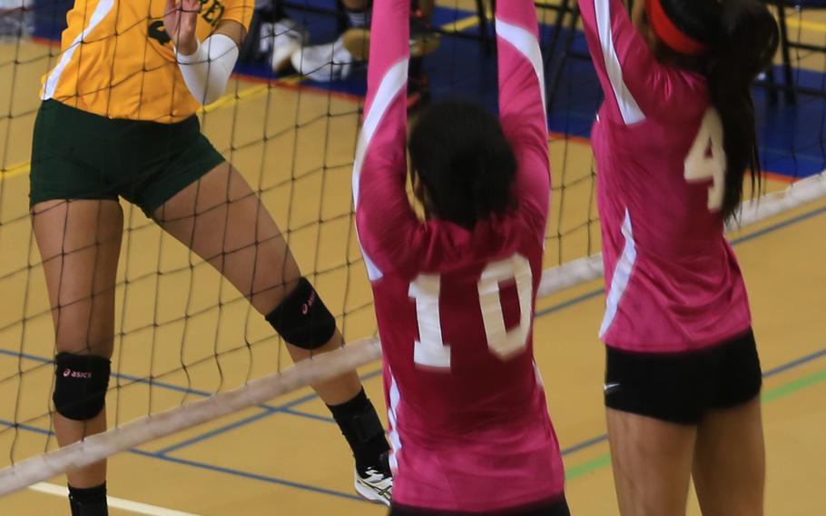 Robert D. Edgren's Naomy Montanez tries to spike between Nile C. Kinnick's Stephanie Stockman and Rhyssa Hizon on the second day of the DODDS Japan girls volleyball tournament Friday. The Red Devils won 27-25, 25-18 25-18.