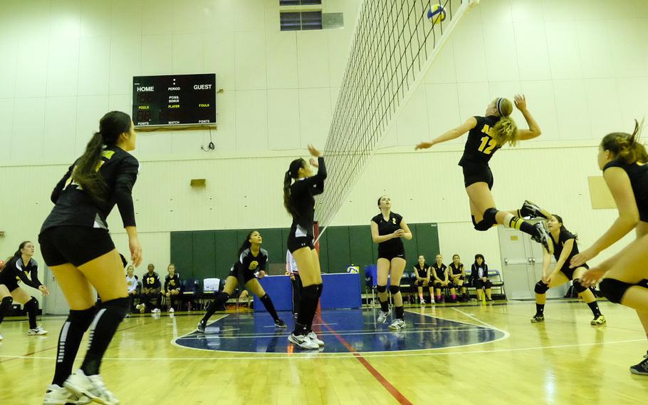 American School in Japan's Mia Weinland attempts a spike kill during round robin play of the Far East Tournament on Tuesday, Nov. 4, 2014, at Yokota Air Base, Japan.