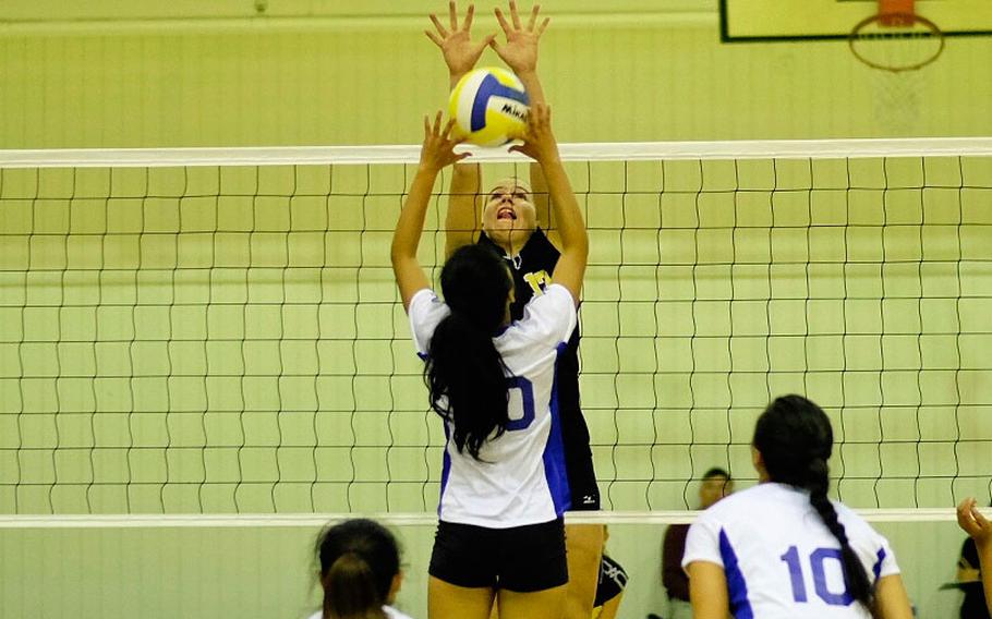 American School in Japan's Mia Weinland blocks Christian Academy of Japan's Jesseca Balona's attack in the first game of the Far East Tournament championship bracket at Yokota Air Base, Japan Nov. 5. ASIJ is looking to win its fourth consecutive Far East Tournament title.