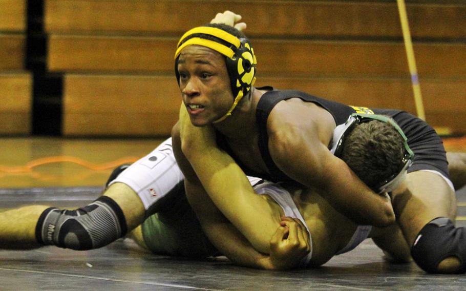 Kadena's Jason Bland finishes off Kubasaki's Tyler Russell in the 141-pound bout of Wednesday's season-opening Okinawa wrestling dual meet. Bland pinned Russell in 1 minute, 10 seconds, and the Panthers won the dual meet 29-28.