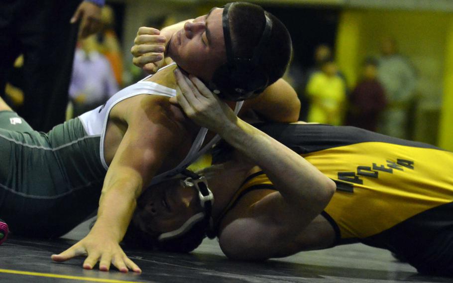 Kubasaki's Jon Orr gains the edge on Kadena's Aaron Harp in the 148-pound bout of Wednesday's season-opening Okinawa wrestling dual meet. Orr pinned Harp in 2 minutes, 38 seconds, but the Panthers won the dual meet 29-28.