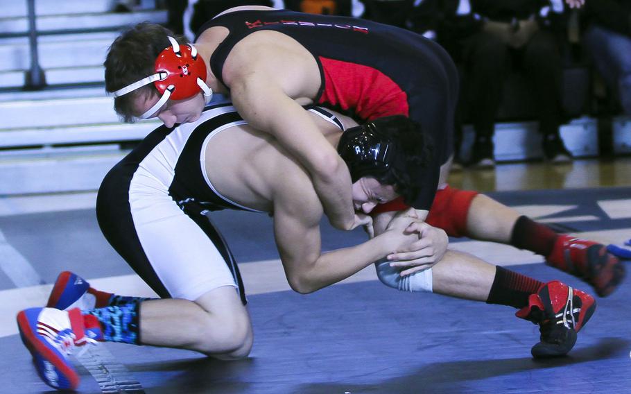 Nile C. Kinnick's Max Nicely gets the upper hand on Zama's Curtis Blunt at 135 pounds. Nicely pinned Blunt in 4 minutes, 1 second and the Red Devils beat the Trojans 58-6, one of their four victories in Saturday's DODDS Japan dual-meet tournament at Zama.