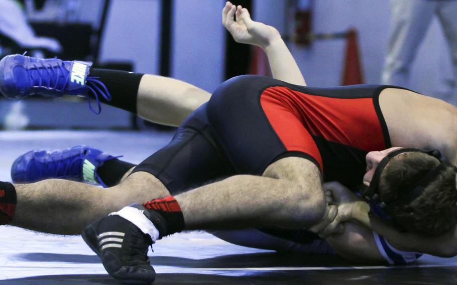 Nile C. Kinnick's Jeremiah Ramos pins Yokota's Emerson Gaume in 1 minute 20 seconds at 129 pounds. The Red Devils beat the Panthers 55-9, one of their four victories in Saturday's DODDS Japan dual-meet tournament at Zama.