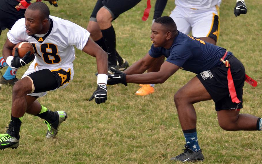 Army receiver Anthony Smith tries to elude Navy defender Tyler Guillory.