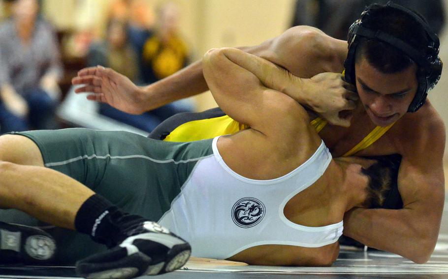 Kadena's Adam Trujillo gets an arm around the head and neck of Kubasaki's Matt Palabrica in the 115-pound bout during Wednesday's Okinawa high school wrestling meet. Trulillo pinned Palabrica in 48 seconds and the visiting Panthers won their second straight dual meet of the season 34-30.