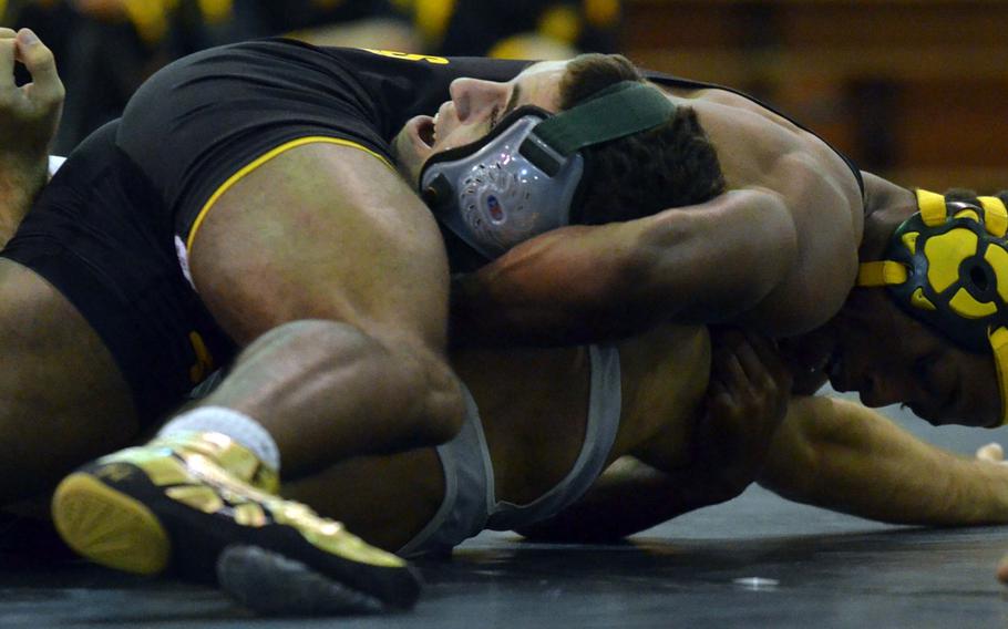 Kadena's Jason Bland finishes off Kubasaki's Tyler Russell in the 141-pound bout during Wednesday's Okinawa high school wrestling meet. Bland pinned Russell in 2 minutes, 32 seconds and the visiting Panthers won their second straight dual meet of the season 34-30.